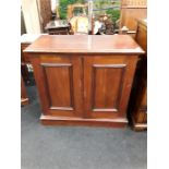 A mahogany cupboard with four interior drawers.