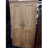 A large pine double door wardrobe.