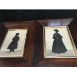 Two Victorian design silhouettes of young ladies in dark rosewood frames.