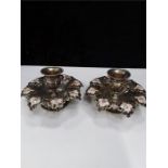 A good pair of American unger bros embossed silver and floral enamelled candlesticks with enameled