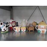 A quantity of collectable teapots inc cow, animals, cottage, etc.