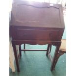 A small oak bureau on a stand.