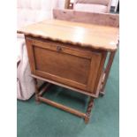 An oak pie crust edge cabinet.