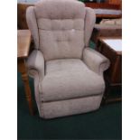 A recliner armchair in beige fabric.