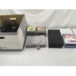 A PlayStation and PlayStation 2 with games and accessories