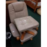 A cream/Brown leather swivel armchair together with a matching pouffe.