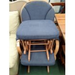 A rocking chair together with a pouffe upholstered in a blue fabric made by Dutailier.