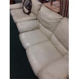 Two cream two seater leather sofas.