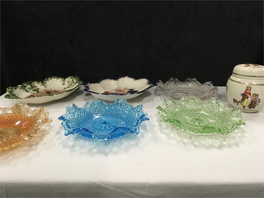 Coloured glass dishes with a Yardley ginger jar.