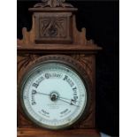 A Benefink fair weather barometer in oak case.