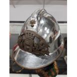 A metal French helmet with brass face, lined.