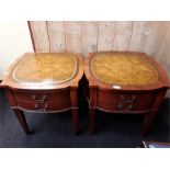 A pair of inlaid leather and mahogany bedside or lamp tables.
