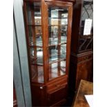 A modern mahogany hexagonal china display cabinet with glazed upper section.