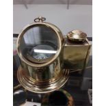 A brass mounted binocular compass under glass.