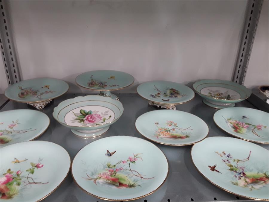 A Victorian Mintons dessert set decorated with butterflies on a green ground with gilt borders