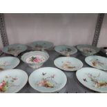 A Victorian Mintons dessert set decorated with butterflies on a green ground with gilt borders