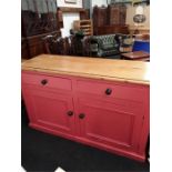 A 19th century pine dresser base painted pink.