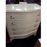 A French style cream and gold chest of five drawers.