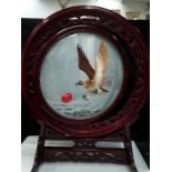 A Chinese needle work revolving table screen on hard wood stand souzu?