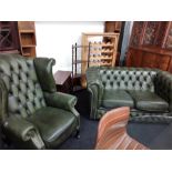 A green leather upholstered two piece suite comprising of a two seater sofa and a living chair.
