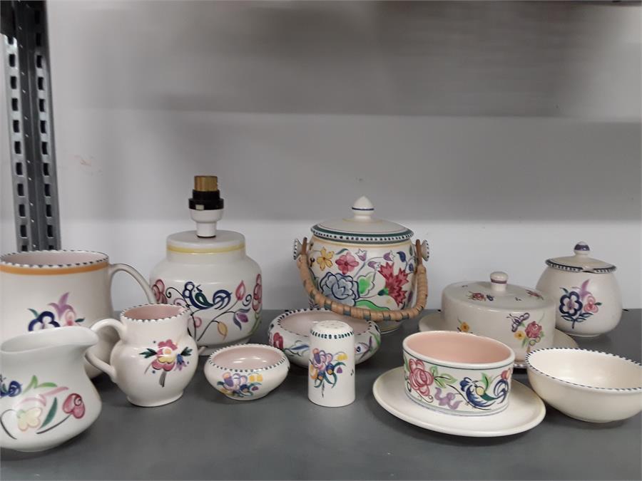 A quantity of Poole Pottery to include a biscuit barrel, butter, marmalade, etc. in floral colours.