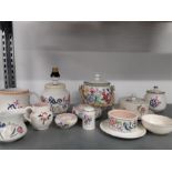 A quantity of Poole Pottery to include a biscuit barrel, butter, marmalade, etc. in floral colours.