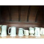 A collection of Pewter mugs related to sailing