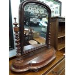 A Victorian mahogany framed dressing table mirror with turned side supports.