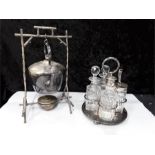 A silver plate kettle on stand and a plated cruet set.