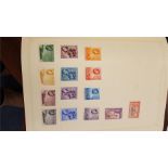 A green album of mixed stamps stamps together with a red album containing New Zealand stamps and a