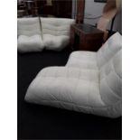 A designer white leather three piece suite.