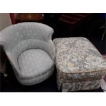 A green upholstered bucket hall chair together with a floral patterned pouffe.