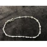 An 18ct white gold bracelet set with 13 diamonds.