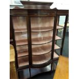 A Victorian mahogany inlaid serpentine fronted china display cabinet with five shelves.
