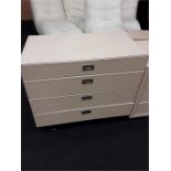 A modern leather chest of four drawers.