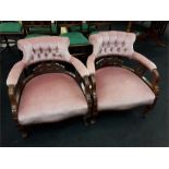 A pair of Victorian mahogany pink upholstered curved back easy chairs.