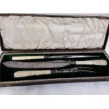 A three piece carving set with silver ferrules and ivory handles.