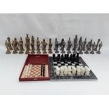 A small onyx chess set, a travel chess set together with silver and gold coloured metal chess