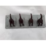 Dog tail hooks on slate base. (R129)