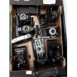 A box of various cameras, mainly retractable.