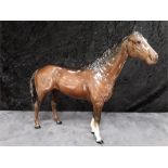 A large Beswick tan and black horse.