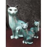 Three green coloured Poole Pottery cats.