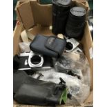 A small box of various cameras and lenses.