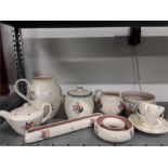 A quantity of traditional pattern Poole Pottery including posy vase, biscuit barrel, fern pot, etc.