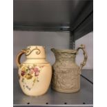 A Royal Worcester buff glazed jug decorated with flowers together with one other jug.