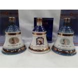 Three boxed and sealed Bell's Whisky decanters 70cl 40% vol, two depicting the Queen Mother's