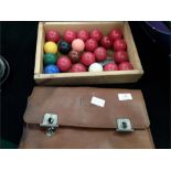 A collection of snooker balls together with a 19c leather cased gents brush toilet.