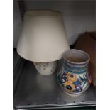 A Poole Pottery lamp together with a Poole Pottery vase decorated with flowers.