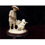 Fine carved group of a gardener with his boy apprentice gathering in fruit 5 inches in height 4 inch