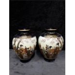 A pair of Japanese Kyoto ware rust and blue satsuma vases decorated with figures.